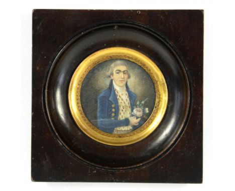 FRENCH SCHOOL, LATE 18TH/EARLY 19TH CENTURY - PORTRAIT MINIATURE OF A GENTLEMAN IN A BLUE COAT, HOLDING FLOWERS IN HIS LEFT H