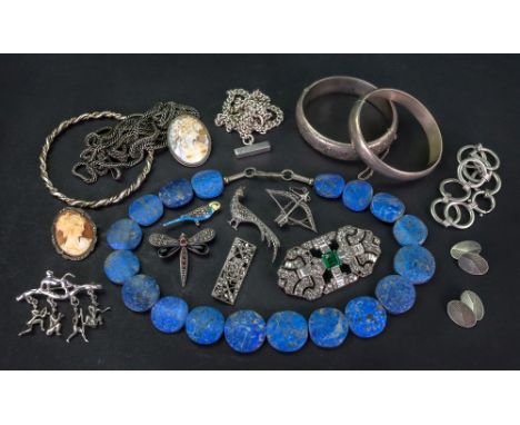 A collection of costume jewellery, comprising; a silver curb link chain with T bar, another chain, two cameo brooches, a silv