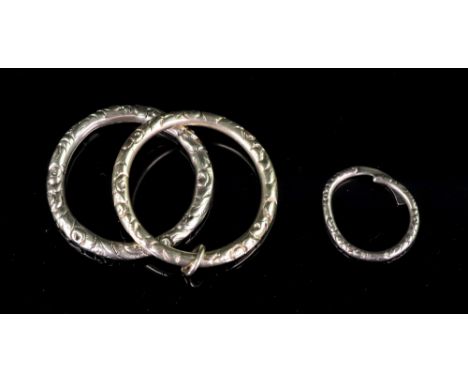 Two gold large split rings, each engraved with scrolling foliate detail and another smaller split ring,11.62g gross combined 