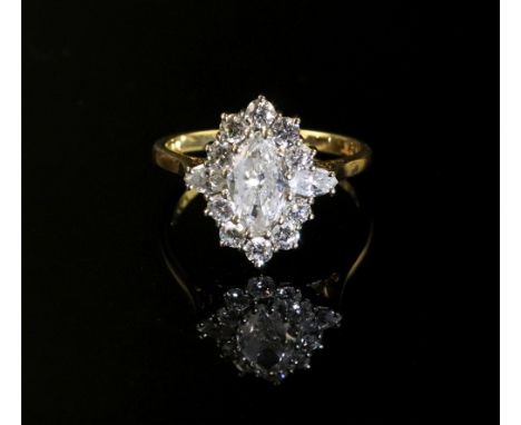 An 18ct gold and marquise diamond cluster ring, the central marquise diamond, weighing approximately 0.65cts, set between two