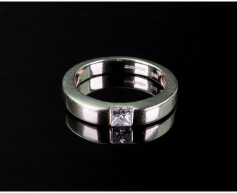 An 18ct white gold and diamond ring, the princess cut diamond, weighing approximately 0.30ct, tension set to white gold band,