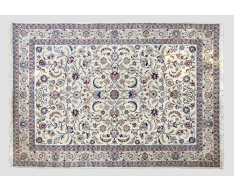 A modern Nain carpet, with a scrolling floral design, on a white ground, set within a floral scrolling border, 350 x 248.5cm.