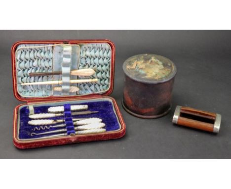 A Victorian rectangular leather cased manicure set, silk and velvet lined, containing whorled mother of pearl handled steel t