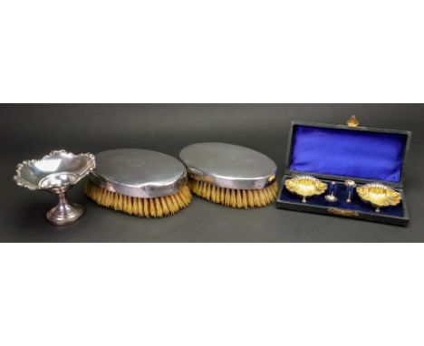 A pair of oval engine turned silver military hair brushes, London 1925, monogrammed, a silver pedestal bon bon dish, Birmingh