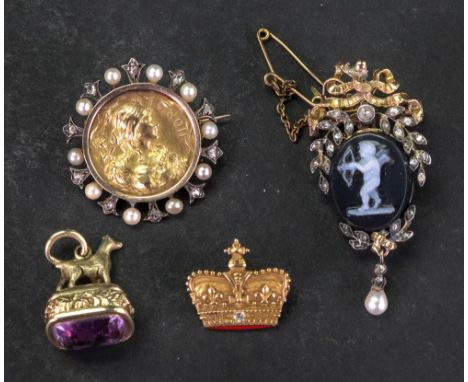 A gold, diamond and onyx cameo brooch, the central oval onyx with winged cupid cameo within diamond set floral surround and c