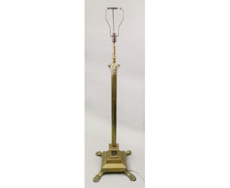A brass corinthian column standard lamp, circa 1900, on a stepped square spreading base with claw feet, 123cm high.