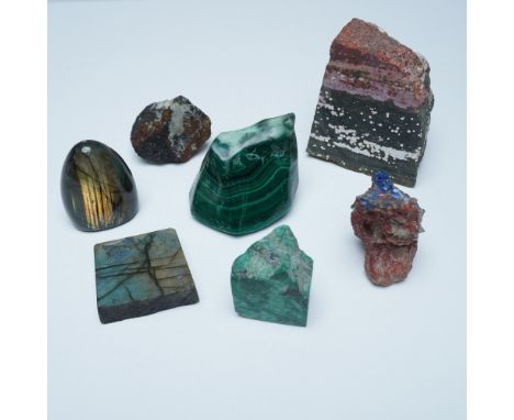 An attractive assortment of seven polished and raw mineral specimens, showcasing a variety of colors, patterns, and natural f