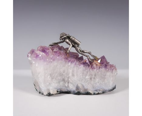 Unique sculptural composition featuring a detailed metal scuba diver figure mounted on a raw amethyst crystal cluster. The di