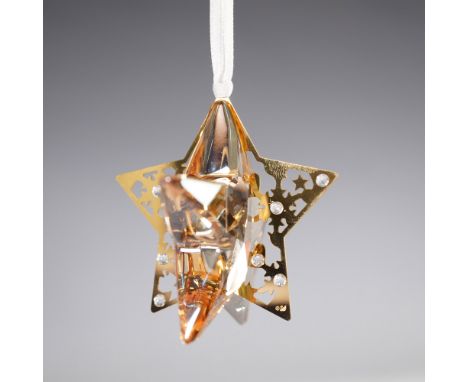 A stunning Swarovski crystal star ornament featuring a golden metal frame adorned with intricate cutout details and embedded 