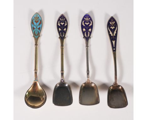 A set of four exquisite gold-plated sterling silver spoons, each featuring intricate enamel detailing on the handles in rich 