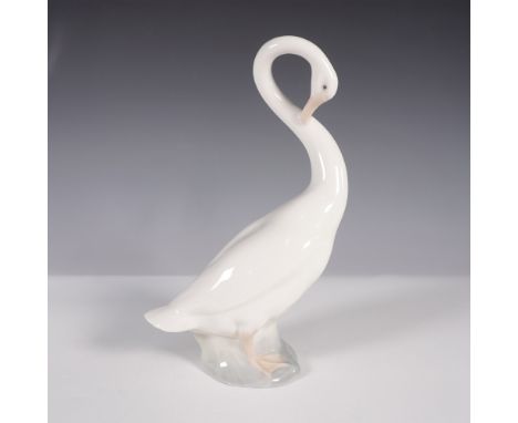 A graceful Nao by Lladro porcelain figurine depicting a long-necked goose with its head elegantly tucked. Crafted in Spain, t