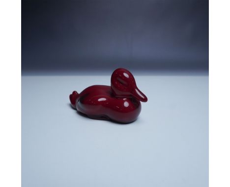 Royal Doulton Flambe Duck sculpture featuring the brands signature deep red flambe glaze. This ceramic piece showcases a styl