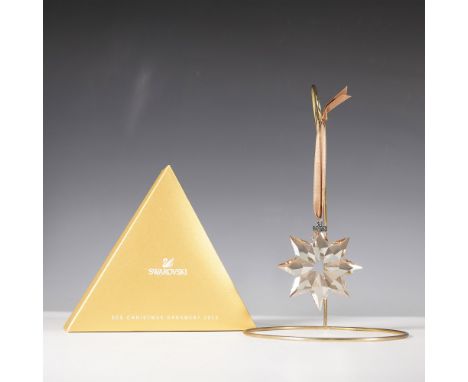 The 2013 Swarovski SCS Christmas Ornament showcases a stunning eight-pointed star, expertly crafted from faceted golden shado