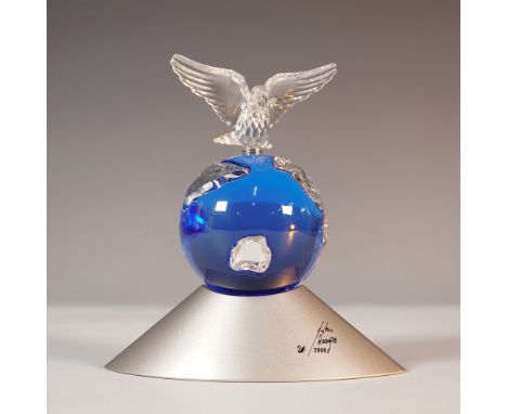 .Swarovski crystal Planet figurine, a retired collectible designed to commemorate the new Millennium. This piece features a b