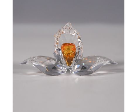 Swarovski crystal figurine featuring an orchid with clear faceted petals and a topaz-yellow crystal center. This piece was is