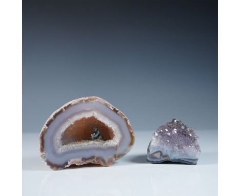 A unique lot featuring two stunning mineral specimens: a natural geode with a crystal-lined interior and a polished amethyst 