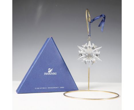 The Swarovski 2002 Christmas Ornament is a dazzling faceted crystal snowflake, designed with precision-cut edges that reflect