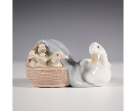 A charming Lladro porcelain figurine titled Ducks (01004895), featuring a mother duck alongside her ducklings nestled in a wo