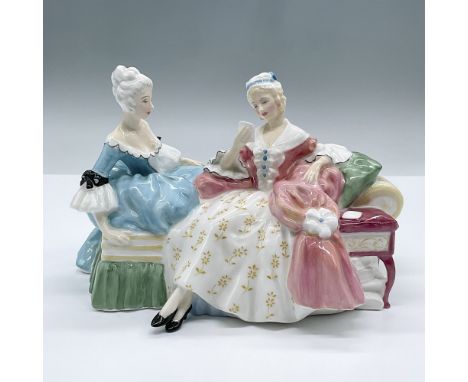A lovely figure of two seated ladies. One is fashioned in a light blue dress and the other a pink and floral dress. Part of t