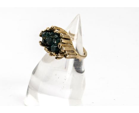 A 9ct gold retro green diopside set dress ring, having natural crystal central stones within a textured baton mount on a hall