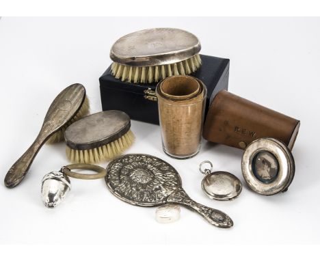 A group of silver and other items, including a clothes brush and comb in box, clothes brush and hair brush, rattle, travellin