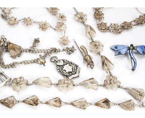 A collection of silver jewels, including a George V silver and enamel dragonfly brooch, a contemporary silver pin modelled as