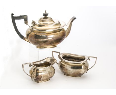 A 1950s silver three piece tea set by Walker &amp; Hall, traditional helmet shaped teapot, sugar basin and milk jug, Sheffiel