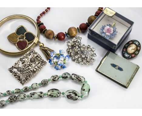 A quantity of costume jewellery, including rolled gold child's bangle, 1960s oval brooch with red stones, a Venetian green gl