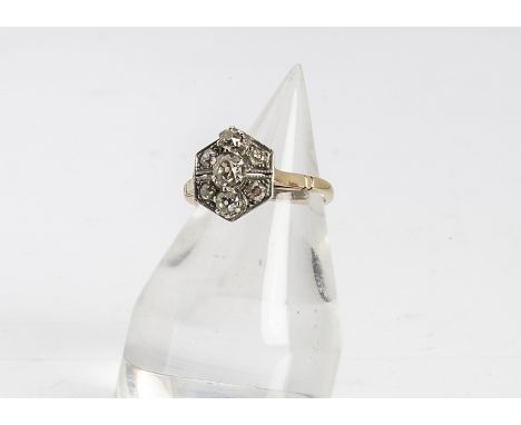 An Art Deco cluster tablet ring, the hexagonal setting centred with three old cut diamonds and four smaller millegrain set di
