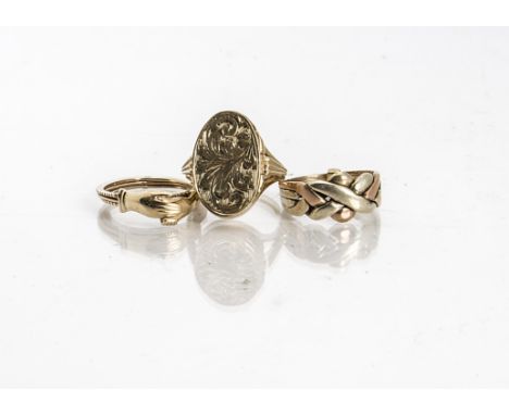 A 9ct gold two colour puzzle ring, ring size L, a 9ct gold two colour metamorphic ring of two clasped hands revealing a hidde