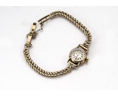 A vintage 9ct gold lady's wristwatch, 18mm Omega case and dial, with later quartz movement, on 9ct gold strap, 17.8g 