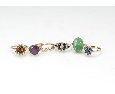 Six gem set rings, including sapphire and diamond, a jade ring, garnet and seed pearl, synthetic colour change corundum and o