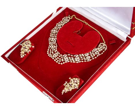 A cased suite of Indian seed pearl and ruby jewels, comprising a five string seed pearl and yellow metal choker united by ele