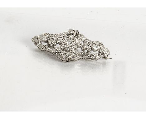 An Art Deco diamond and platinum set architectural brooch, of pierced design centred with old cut millegrain set diamonds, ap