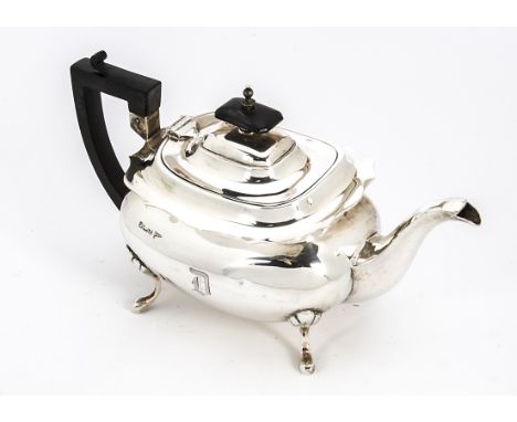 An Edwardian silver teapot by Walker &amp; Hall, scalloped flange rim with plain bearing initial D, on four supports, bent, a