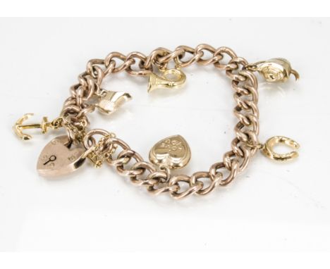 A 9ct gold curb link charm bracelet, the padlocked bracelet with six charms including an anchor, heart, teapot, bugle and oth