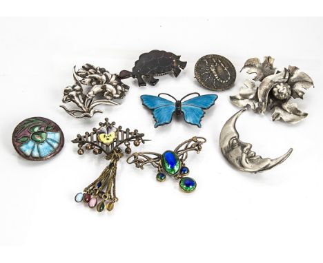 A collection of silver brooches, including an enamel butterfly, a base metal and enamel drop and various others 