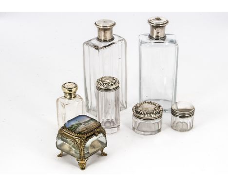 A pair of early 20th century French cut glass and silver capped dressing table bottles, together with four cut glass and silv