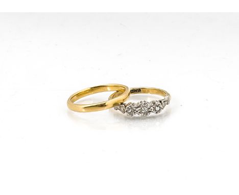 An 18ct gold three stone illusion set diamond ring, ring size K, 2.5g together with a 22ct gold octagonal wedding band, ring 