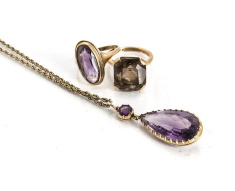 An amethyst pear shaped drop pendant, in 9ct gold, a 9ct gold amethyst dress ring, ring size P, and a 9ct gold smoky quartz r