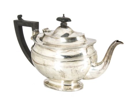 A George V silver teapot from C.S. Harris &amp; Sons Ltd, oval on spreading foot, with applied black handle and finial, 19.3 