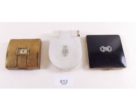 An Evans compact with watch to lid, a Kigu compact and a Coty compact with integral lipstick 