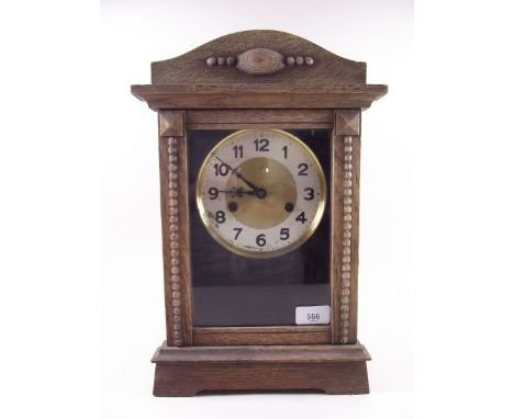 An oak carved striking mantel clock 38cm 