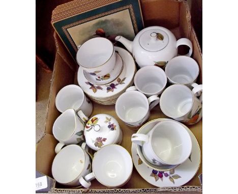 An Royal Worcester Evesham tea service comprising:- teapot, milk, jam pot with lid, six tea plates,   one breakfast cup and s