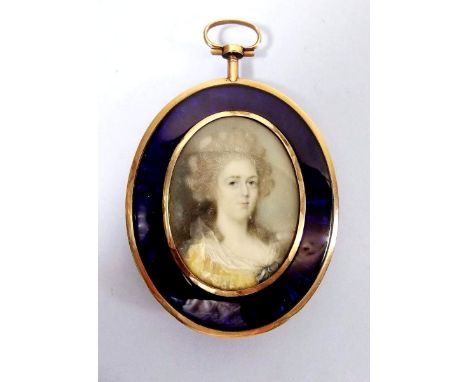 A late 18th century/early 19th century portrait miniature on ivory of a lady in yellow dress enclosed with blue enamel oval f