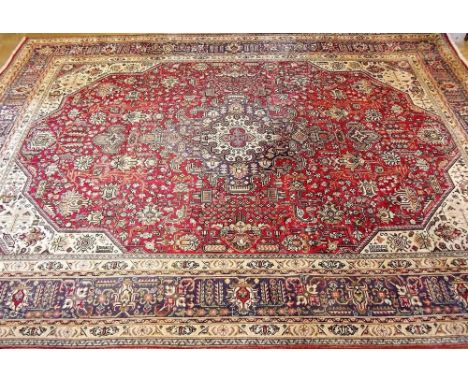 A large Persian style carpet on a blue ground - 3.5 x 2 m approx.