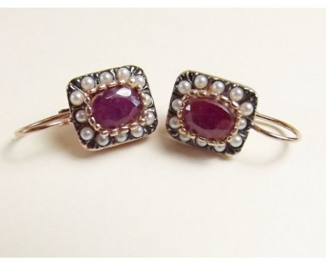 A pair of silver gilt cluster earrings set cushion cut ruby and seed pearls