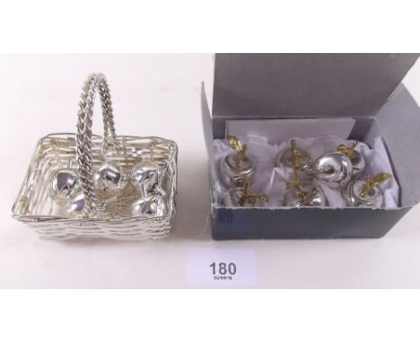 A set of six silver plated apple form placemat holders boxed and a similar set in basket 