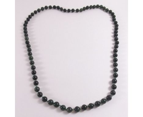 A string of dark green 'jade' beads 