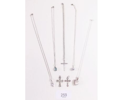 Three silver crucifix and four other silver necklaces 